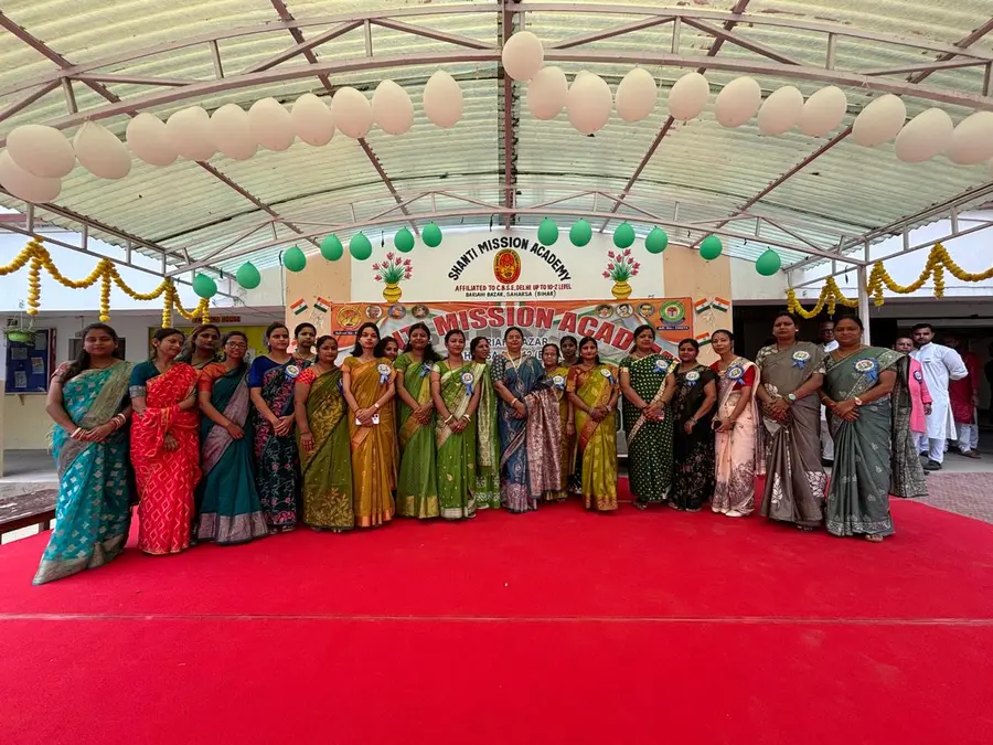 Staff group under the school banner
