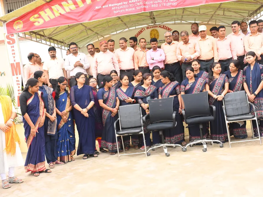 Staff and students under the school banner