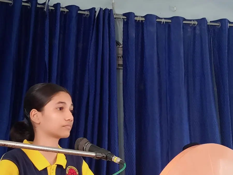 A student speaking at the school podium