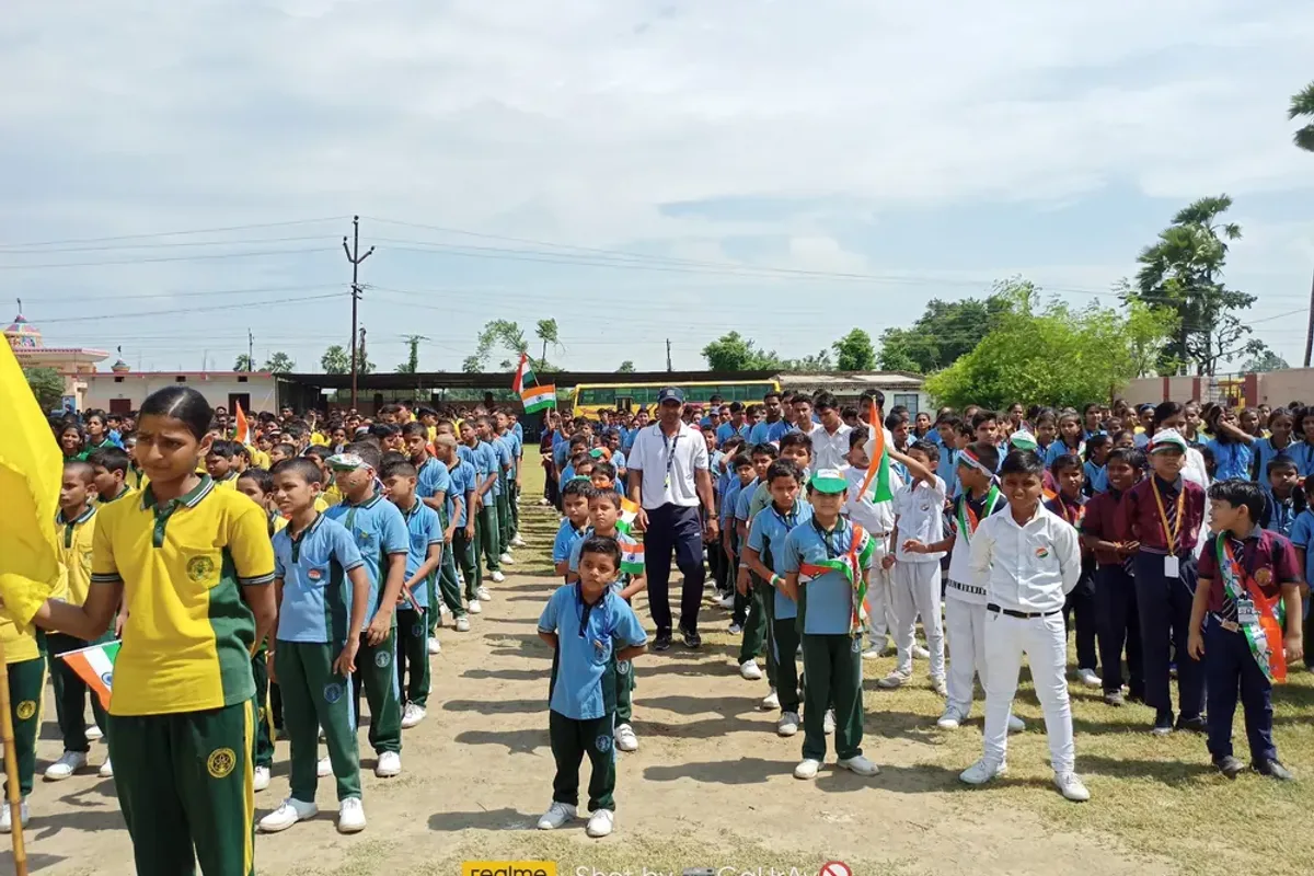The school lined up on the ground with the house flags
