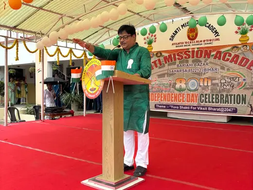 Addressing the school from the podium